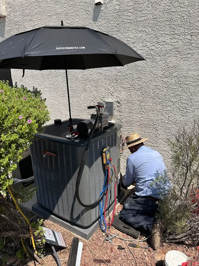 HVAC technician performing outdoor AC maintenance in Summit Park